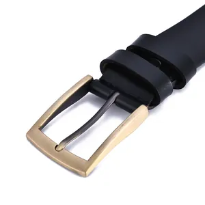 Detail of vintage men's black leather belt featuring a matte bronze-tone pin buckle