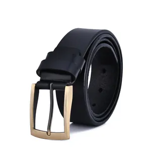 Detail of vintage black leather belt with classic brass buckle and fine texture