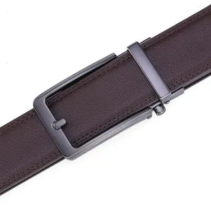 Detail of men's brown leather belt showing fine lychee texture and matte metal buckle