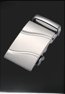 Detailed view of silver automatic belt buckle with brushed texture and wave pattern