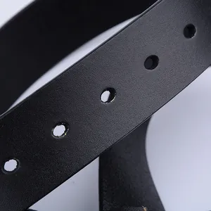 Detailed close-up of matte black leather belt showing fine texture and clean pin holes