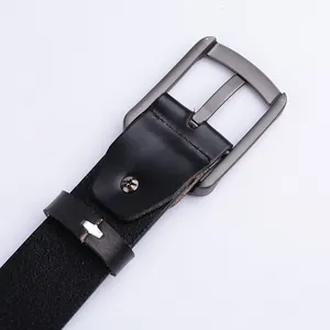 Detailed macro view of the textured black leather belt and dark gunmetal pin buckle