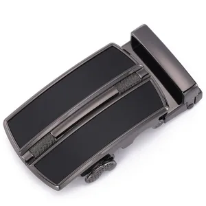 Detail of gunmetal automatic belt buckle with textured crosshatch design for men