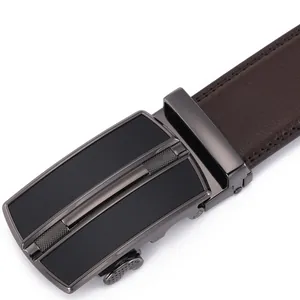 Macro view of gunmetal alloy automatic buckle and textured brown leather belt