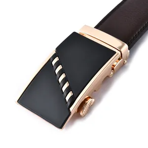 Detail of men's automatic buckle belt featuring gold metal finish and brown leather