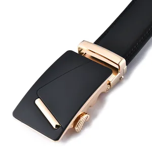 Detail of black leather belt with matte black and gold automatic alloy buckle finish
