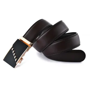 Detailed close-up of dark brown leather belt with luxury gold striped automatic buckle