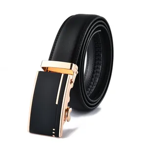 Detail of black leather belt with gold automatic buckle and subtle textured finish