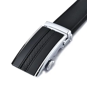 Macro detail of men's leather belt with polished silver automatic buckle and textured inlay