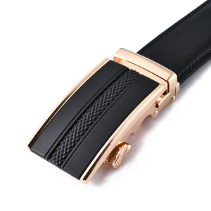 Close-up of men's leather belt with rose gold automatic buckle and textured black inlay