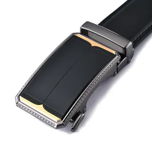 Detailed macro view of gunmetal belt buckle with Greek key patterns and gold accents
