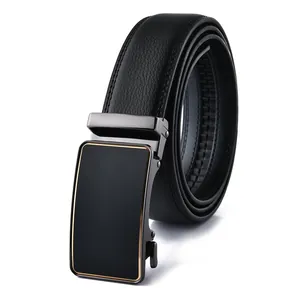 Close-up of black leather belt with matte automatic buckle and gold metal trim detail