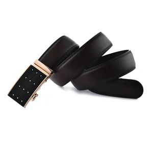 Macro detail of dark brown leather belt with black and gold automatic buckle and litchi texture