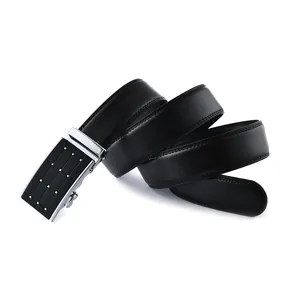 Detail of black cowhide leather belt with textured silver automatic buckle design