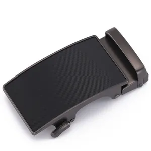 Detail of gunmetal alloy automatic belt buckle with textured diagonal stripes