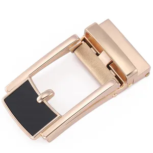 Detail of automatic gold metal belt buckle with textured black panel for men's leather belts