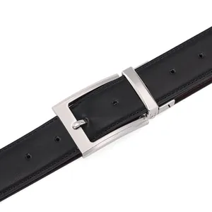 Macro shot of men's leather belt featuring silver rotating buckle and lychee texture