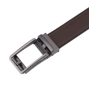 Macro detail of the gunmetal automatic buckle and dark brown lychee textured leather belt