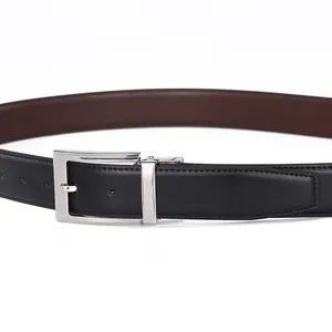 Detail of reversible leather belt with rotatable silver buckle in black and brown