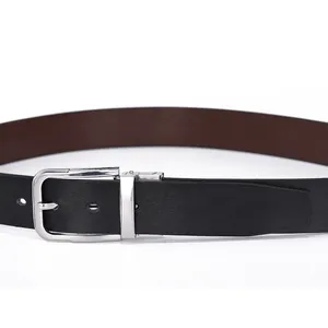 Close-up of rotatable silver metal buckle and textured black and brown leather belt