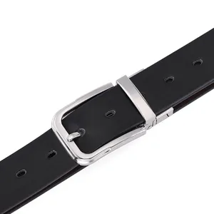 Close-up of polished silver buckle and textured black leather belt with rotation detail