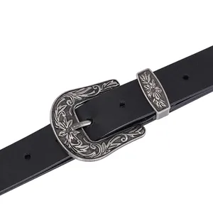 Macro detail of western vintage floral engraved silver buckle on 2.8cm black leather belt