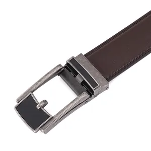 Detailed macro view of retro silver automatic buckle with dark brown leather belt textures