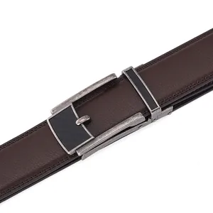 Detail of dark brown leather belt featuring lychee texture and brushed metal buckle