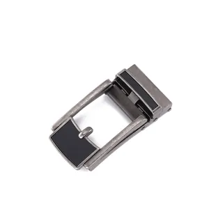 Close-up of vintage automatic belt buckle with matte metal finish and brushed texture