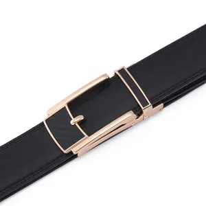Detail of black leather belt with automatic gold buckle and carbon fiber inlay