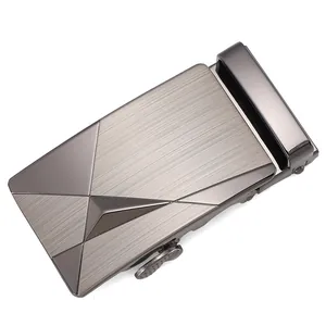 Detail of gunmetal alloy belt buckle with a brushed metal finish and geometric design