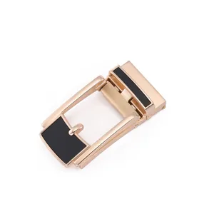 Macro view of rose gold automatic belt buckle with black brushed texture detail