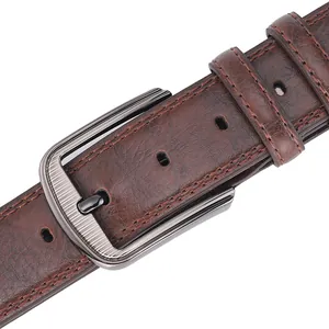 Close-up of brown leather belt with brushed gunmetal pin buckle and textured stitching