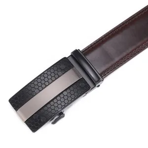 Detail of brown leather belt with black honeycomb buckle and fine double stitching