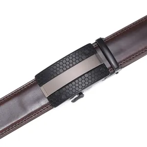 Detail of dark brown leather belt featuring black hexagon textured automatic buckle