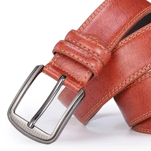 Detail of dark brown leather belt with brushed metal pin buckle and fine stitching