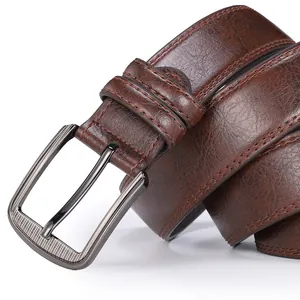 Detail of dark brown vintage leather belt with gunmetal buckle and double stitching