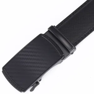 Detail of men's black automatic buckle belt with carbon fiber texture and Greek key pattern