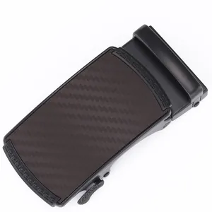 Close-up of men's automatic belt buckle with carbon fiber texture and Greek key pattern