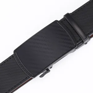 Macro view of men's black leather belt with carbon fiber texture and Greek meander buckle
