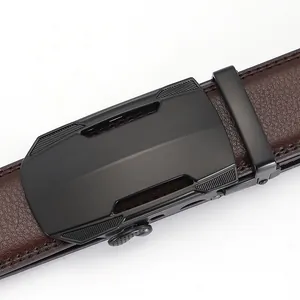 Close-up of brown leather belt with lychee texture and matte black automatic buckle