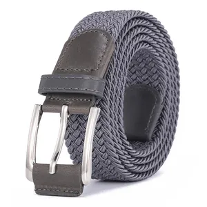 Detail of dark grey elastic braided belt with silver metal buckle and leather trim