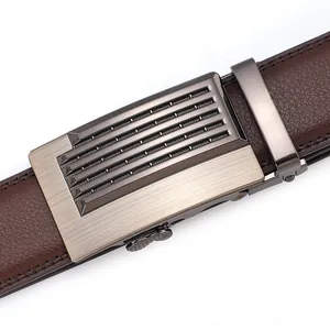Detail of men's brown lychee leather belt with gunmetal automatic brushed buckle