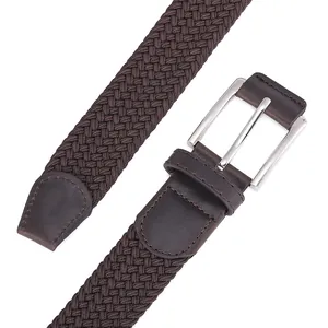 Close-up of dark brown elastic woven belt featuring a silver metal pin buckle and leather detail