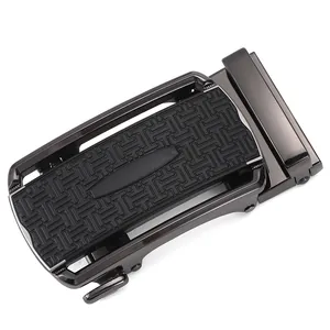 Close-up of gunmetal automatic belt buckle with black geometric textured inlay pattern