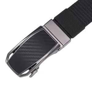 Detail of gunmetal automatic buckle with carbon fiber texture on black nylon belt