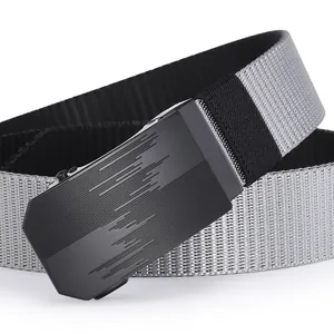 Close-up of matte black metal buckle with embossed lines on grey woven nylon belt