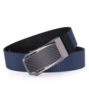 Detail of navy nylon belt featuring a gunmetal buckle with carbon fiber texture inlay