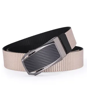 Detail of men's nylon belt with carbon fiber texture automatic buckle and khaki strap