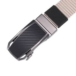 Detail of grey metal automatic buckle with carbon fiber texture on khaki canvas belt